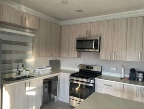 Enjoy cooking in this well-equipped kitchen with an oven, microwave, and dishwasher.