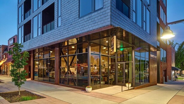 A modern building with a glass storefront and a sign that reads "MARKET HOUSE".
