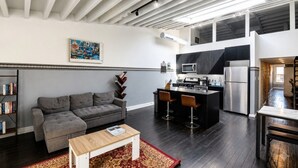 A modern apartment with a living room, kitchen, and dining area.