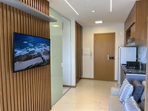 A modern kitchen with a built-in oven, microwave, and sink.