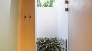 A doorway with a stone wall and a potted plant. - Beach Front Earth Suites #1 (Playa Guiones)