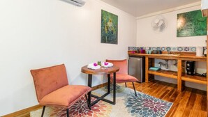 A compact kitchen with a dining area, featuring a small table with chairs, a refrigerator, and a sink. - The Surf Shack - With direct beach access (Playa Guiones)