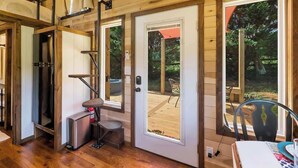 A wooden interior with a sliding glass door leading to an outdoor deck.