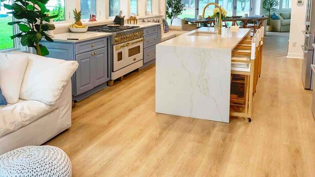 A spacious kitchen with a central island, large windows, and a dining area. - Thorneton Point Estate (Easton)