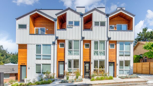 A modern multi-story residential building with a symmetrical facade, large windows, and a mix of white and wooden paneling. - Cheerful 3-bedroom New Townhouse near UW/Seattle Children's, Free Parking, AC (Seattle)