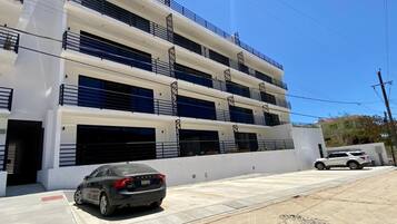 A multi-story parking garage with several cars parked.