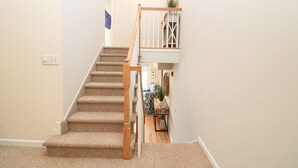 A carpeted staircase with wooden handrails leading to a landing. - New Listing! Beautiful 2000 Square Foot Multi-Level Townhome. 1 BLOCK FROM BEACH (Seaside Heights)