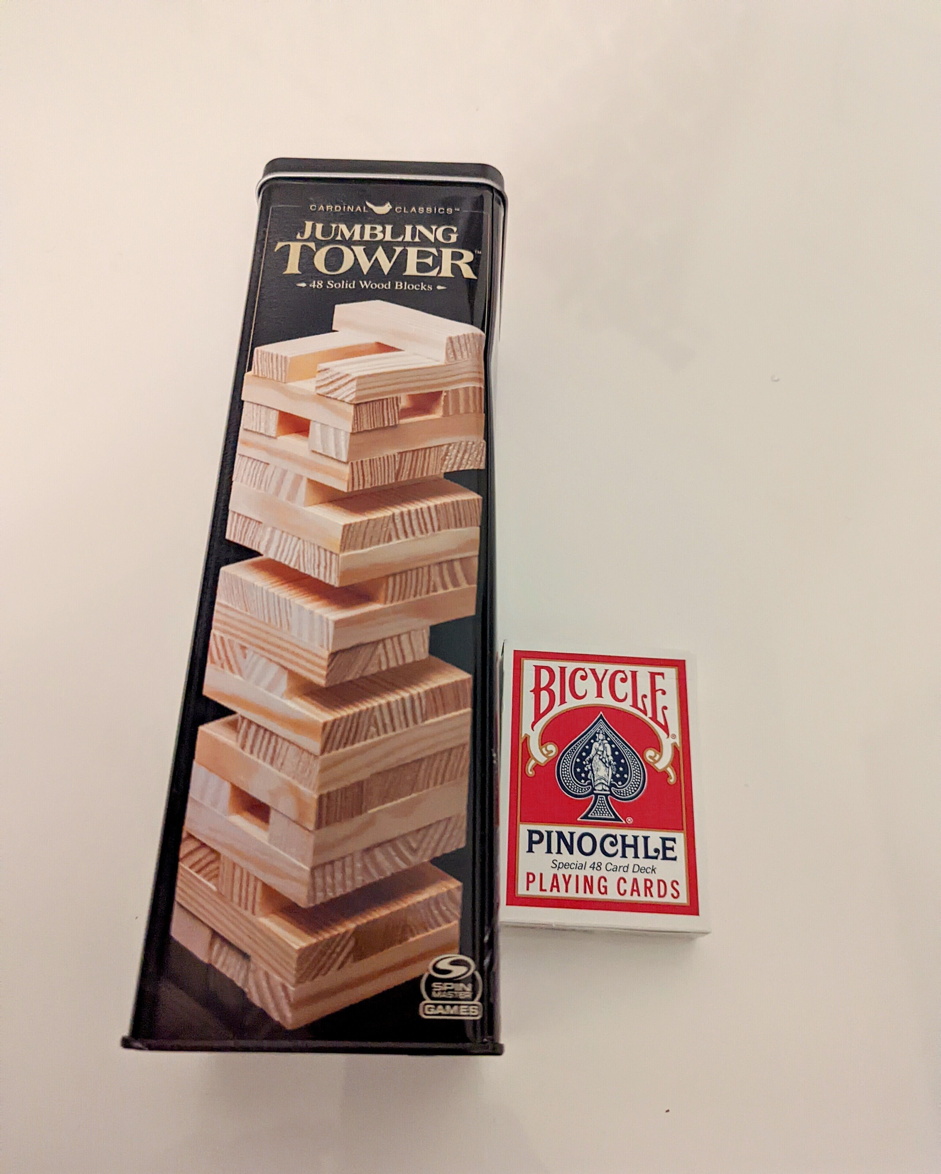 A JUMBLING TOWER card game box with a stack of wooden blocks and a separate playing card deck.