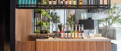 A bar area with wooden paneling, a variety of bottles, glasses, and a counter.