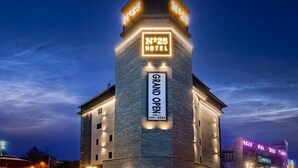 A hotel with a prominent sign indicating it is number 25 and has a grand opening.