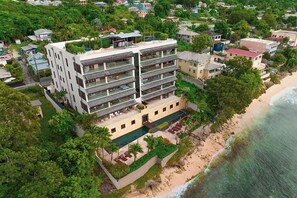 Stunning ocean views from every floor, surrounded by lush greenery and a sandy beach.