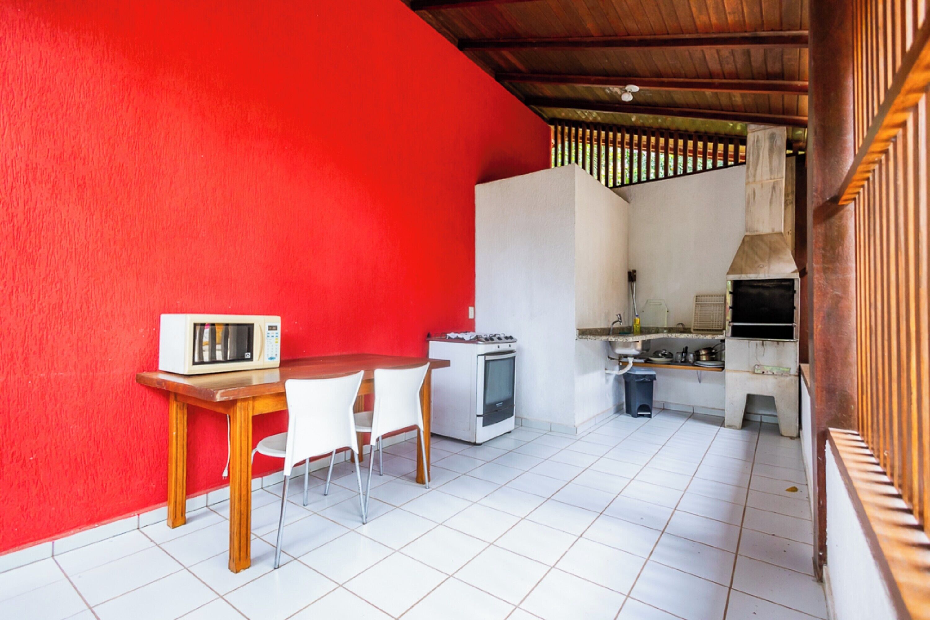 Una cocina compacta equipada con microondas, estufa y lavabo.