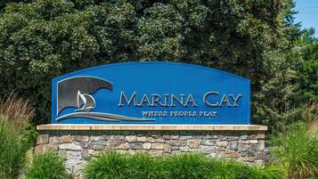 A sign for Marina Cay with a sailboat logo and the text "Marina Cay Where People Play".