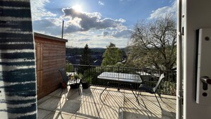 A balcony with a view of a town, a wooden structure, and a metal railing. - Brecon View by Switchback Stays (Newport)