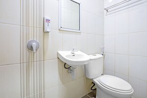 Bathroom features a sink, toilet, and hand dryer.