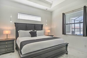 Relax in a serene bedroom with a large bed, bedside tables, and lamps.