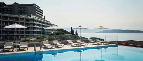 Seasonal outdoor pool, open 9:00 AM to 7:00 PM, pool umbrellas