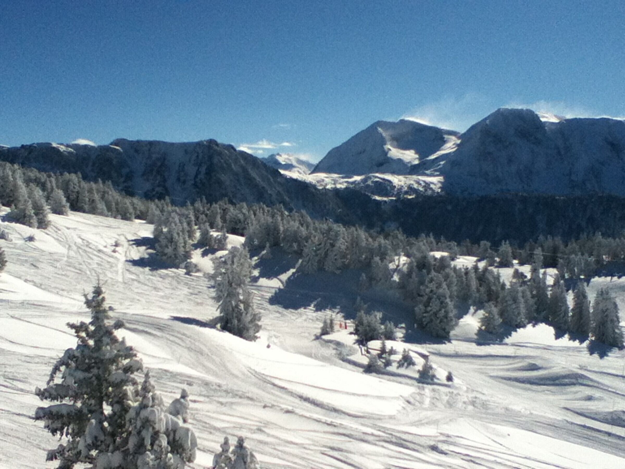 A snowy mountain landscape with a clear sky.