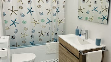 Bathtub, hair dryer, towels, soap