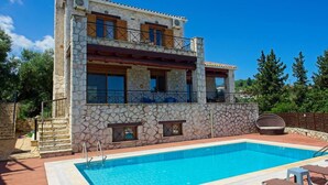 A two-story stone building with a swimming pool and outdoor seating. - Villa Petalouda Stunning Villa in Tragaki Zante (Zakynthos)