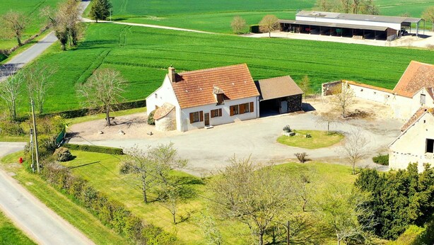 A rural village with traditional houses, a church, and expansive green fields. - Charming Detached Cottage with Large Garden, Near Forest and Karting (La Celette)