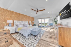 Luxury primary suite with king bed and private sunset deck. - Bayfront Beauty - Stylish Bay Front Escape with Fire Pit (Avalon)