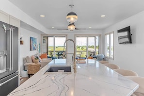 Newly renovated kitchen with large island and modern appliances. - Bayfront Beauty - Stylish Bay Front Escape with Fire Pit (Avalon)