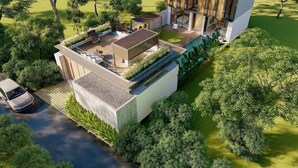 A modern house with a flat roof, large windows, and a patio area with outdoor furniture. - RED SUNSET VILLA CANGGU 5 MIN WALK BEACH (Canggu)