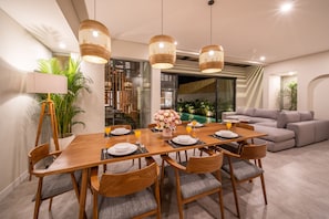 Enjoy meals with family and friends in this spacious dining area, complete with a wooden table and comfortable seating for six.