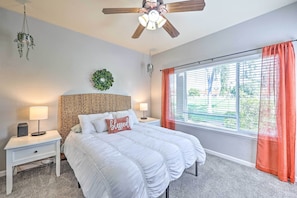 A bedroom with a bed, two bedside tables, a ceiling fan, a window with curtains, and a wall-mounted plant. - Golf Course Views & Pool Access: Glendale Condo! (Glendale)