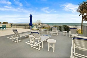 Terrace/patio - Discover paradise at Seascape Towers in New Smyrna Beach. This 3BR/2BA oceanfront condo features a remodeled walk-in shower, spacious layout, and wraparound balcony with sweeping views—just steps from the sand and local attractions. (New Smyrna Beach)