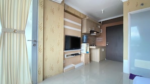 A modern kitchen with a built-in TV, a microwave, and a coffee machine.