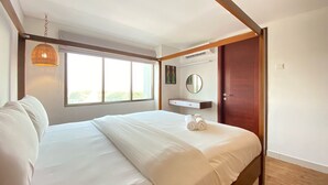 A modern hotel room with a large bed, a bedside table, a mirror, and a window with a view. - Spacious 2Br Apartment Tamansari Tera Residence (Bandung)