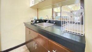 A kitchen with a sink, a toaster, and a white metal rack. - Spacious And Modern 2Br At Braga City Walk Apartment (Bandung)