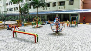 A playground with various play structures and a bench. - Cozy And Warm 2Br At Kebagusan City Apartment (Jakarta)