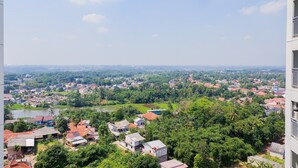 A residential area with houses, greenery, and a river. - Fancy And Nice Studio Apartment At Serpong Garden (Cisauk)