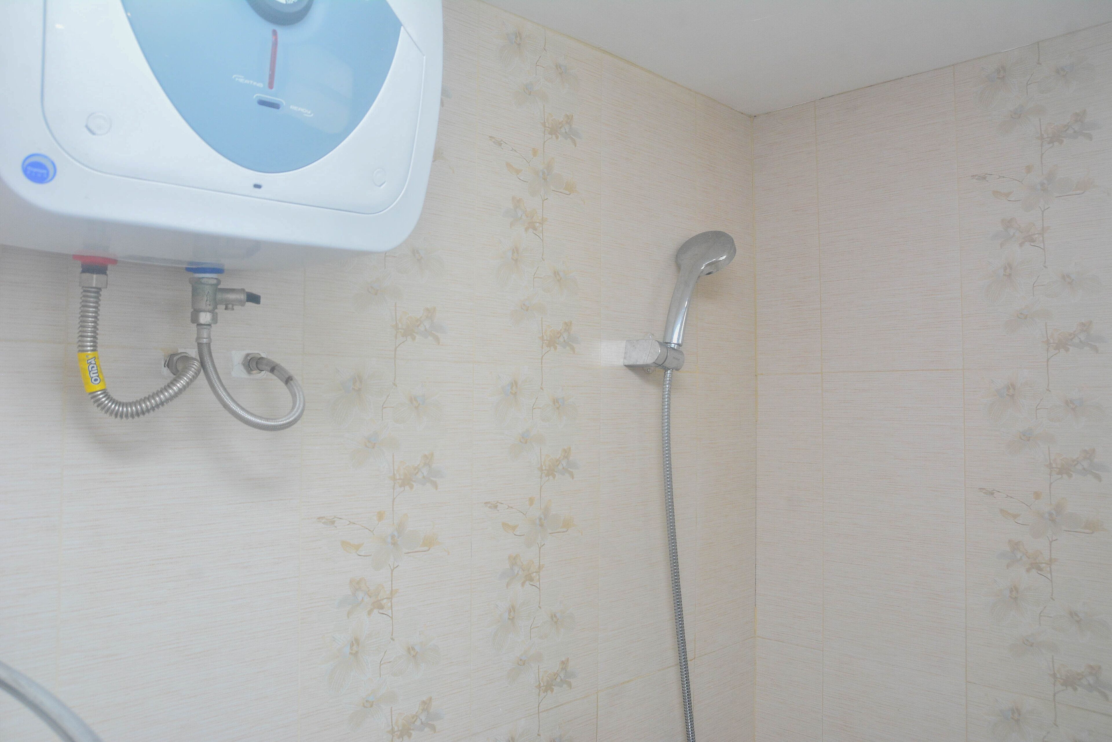A bathroom with a shower, a sink, and a toilet.