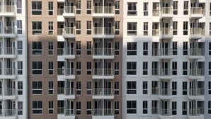 A multi-story residential building with balconies and a uniform facade.