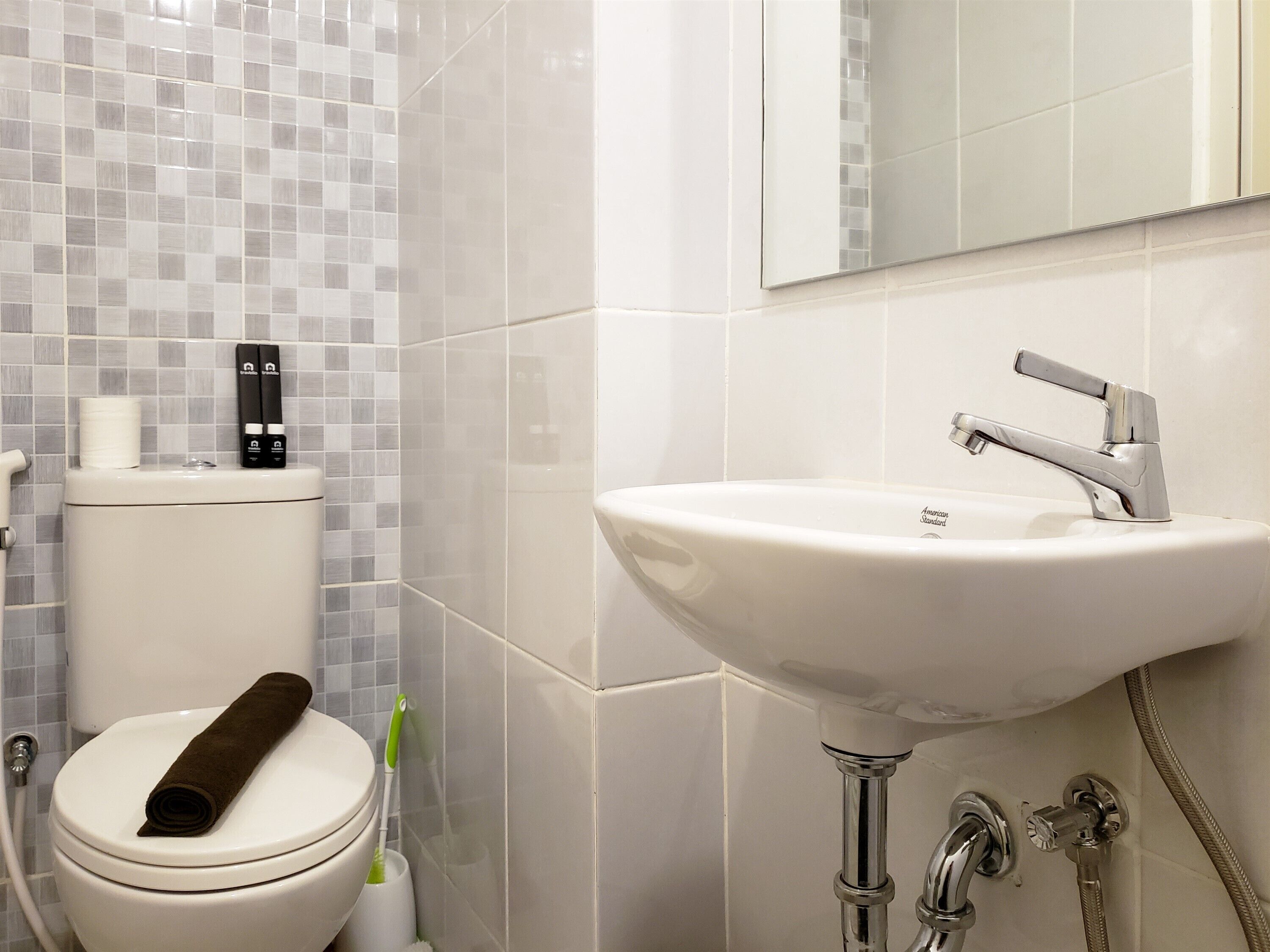 A bathroom with a toilet, a sink, and a shower.