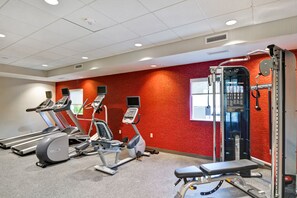 A gym with treadmills, elliptical machines, a bench press, and a weight machine. - Home2 Suites by Hilton Scottsdale North (Scottsdale)