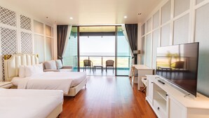 A hotel room with two beds, a TV, and a balcony with a view. - Sea Sand Sun Hua Hin by JC Kevin Hotel & Resort (Cha-am)
