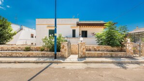 A modern two-story building with a stone facade, a flat roof, and a gated entrance. - 3119 A Casa di Giulia e Sofia by Barbarhouse (Racale)