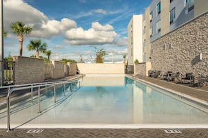 Una piscina al aire libre, sombrillas