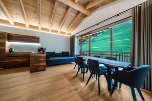 A modern kitchen with wooden cabinets and a dining area with a wooden table and chairs.