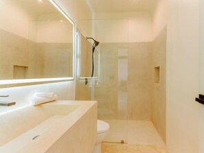 A modern bathroom with a glass-enclosed shower, a large sink, and a toilet. - 5th Ave Rooftop Pool with Ocean Views and BBQ (Playa del Carmen)