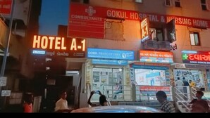 A building with signs for Hotel A-1, Gokul Hospital & Nursing Home, and Gokul Photo Studio. - Hotel A1 Vastrapur (Ahmedabad)