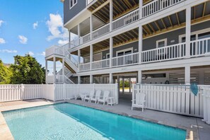 A multi-story building with a pool and outdoor seating. - Semi-Oceanfront Dog Friendly w/ Pool, Hot Tub, Tiki Bar, Game Room, Beach Nearby (Avon)