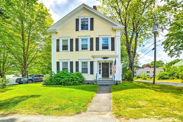 A two-story house with a front porch, a driveway, and a lawn. - Kennebunk Apartment w/ Local Beach Access! (Kennebunk)