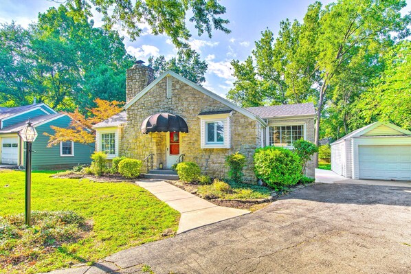 A stone house with a front porch, a garage, and a well-maintained lawn. - Idyllic Springfield Haven w/ Screened Porch! (Springfield)