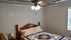 A bedroom with a bed, a nightstand, a lamp, and a ceiling fan. - Country Living with Kyle Field 30 minutes away (SOMERVILLE)